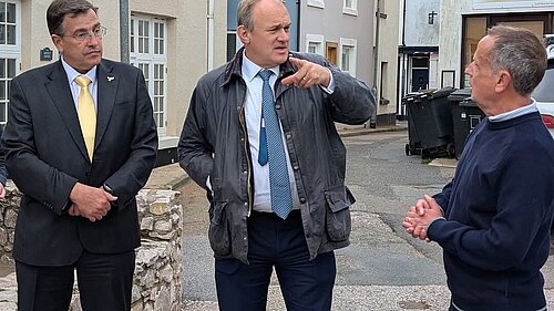 Martin Wrigley and Ed Davey talk to a constituent